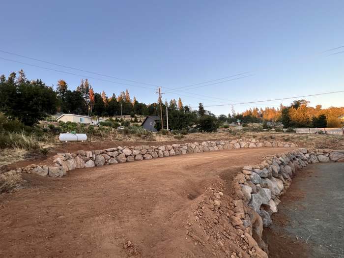A graded lot finished with a curved rock border
