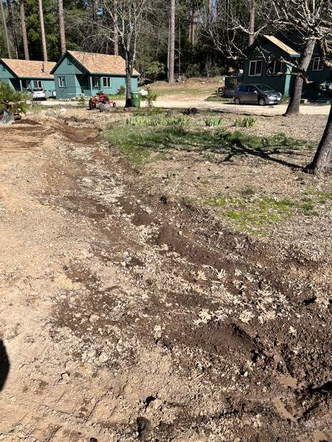 A lot between cabins cleared down to bare ground