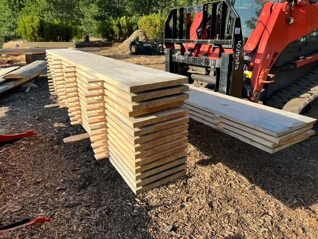 A stack of boards milled from removed trees