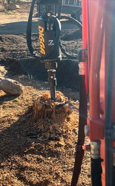 The stump planer attachment working into an old stump